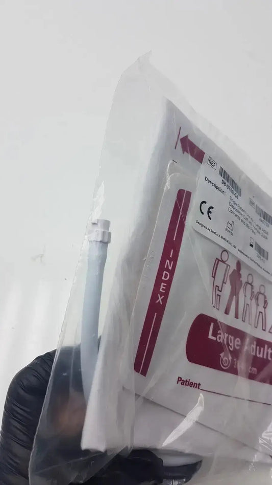 Large sterile adult surgical drape in clear plastic packaging with red and white labeling for blood pressure cuff use